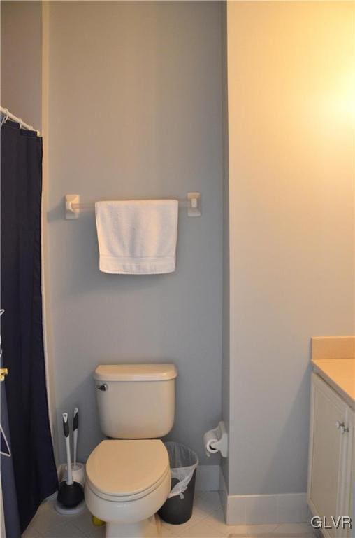 bathroom featuring vanity, tile patterned flooring, and toilet