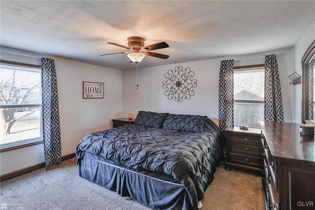 carpeted bedroom with multiple windows and ceiling fan