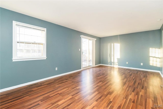 unfurnished room featuring hardwood / wood-style flooring