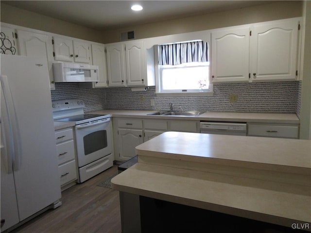 kitchen with dark hardwood / wood-style floors, white cabinetry, sink, backsplash, and white appliances