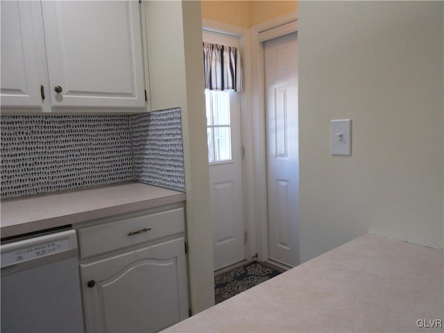 kitchen with white cabinetry, dishwasher, and backsplash