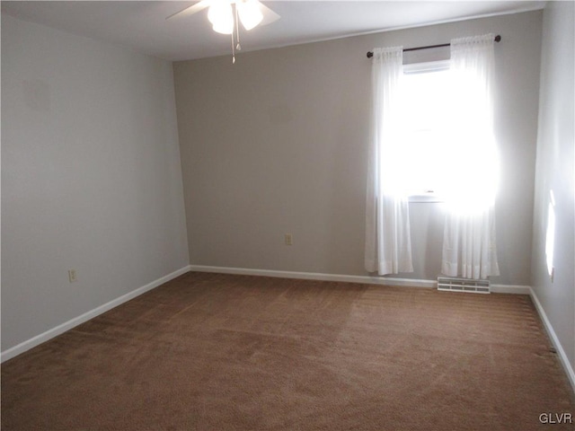 carpeted empty room featuring ceiling fan