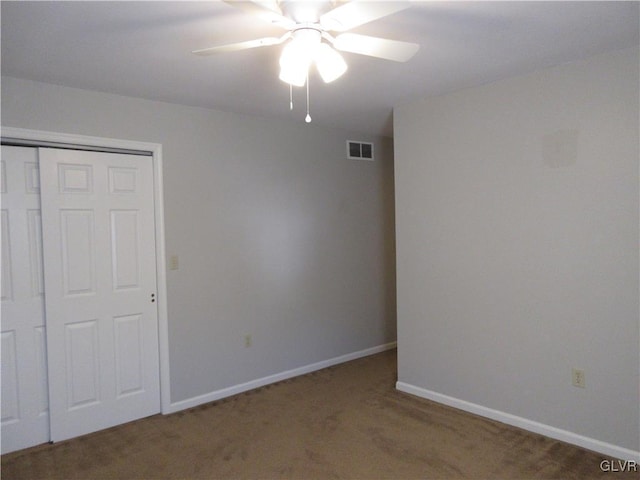 unfurnished bedroom featuring ceiling fan, carpet floors, and a closet