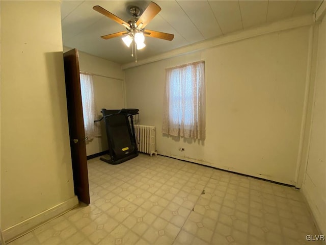 clothes washing area with ceiling fan and radiator