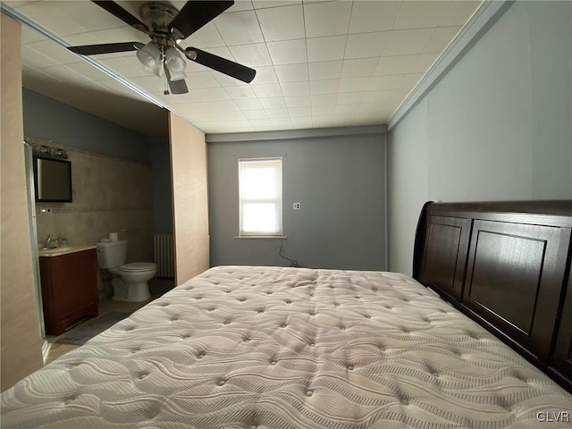 bedroom with sink, radiator heating unit, and ceiling fan