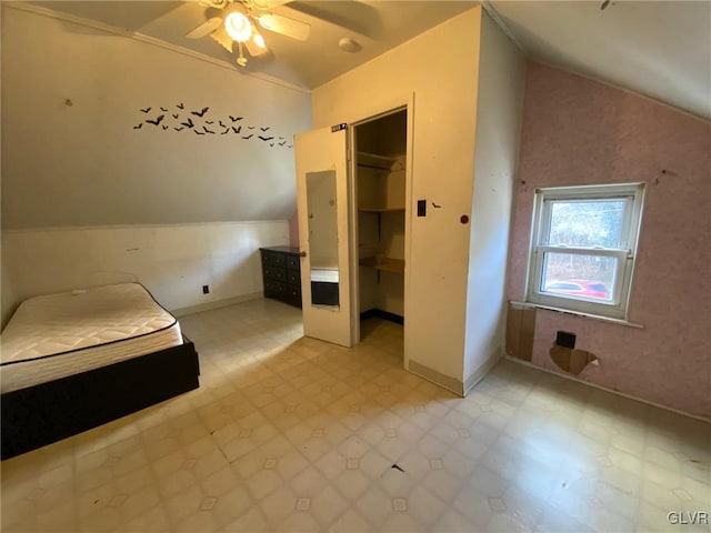 unfurnished bedroom featuring vaulted ceiling and a closet