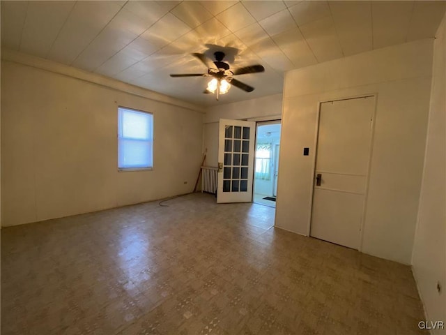 empty room with ceiling fan and radiator heating unit