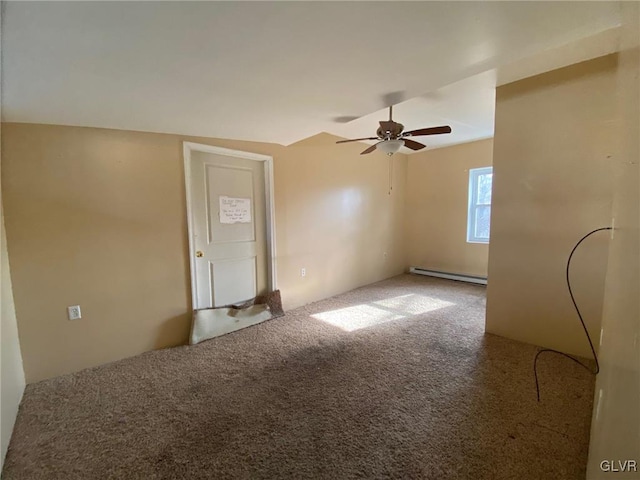 empty room with carpet floors, a baseboard heating unit, and ceiling fan