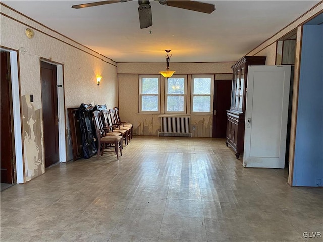 interior space featuring ceiling fan and radiator heating unit