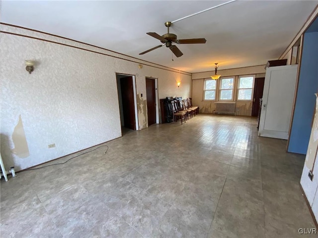 unfurnished room with radiator, ornamental molding, and ceiling fan