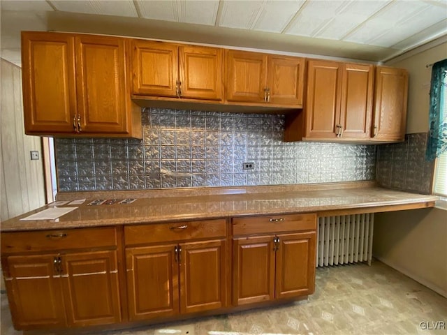 kitchen featuring radiator and decorative backsplash