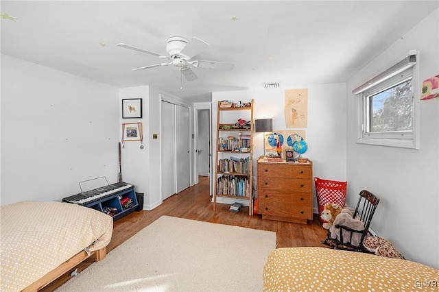 bedroom featuring a closet, ceiling fan, and light wood-type flooring