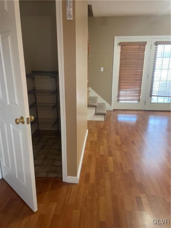 hallway with light hardwood / wood-style floors