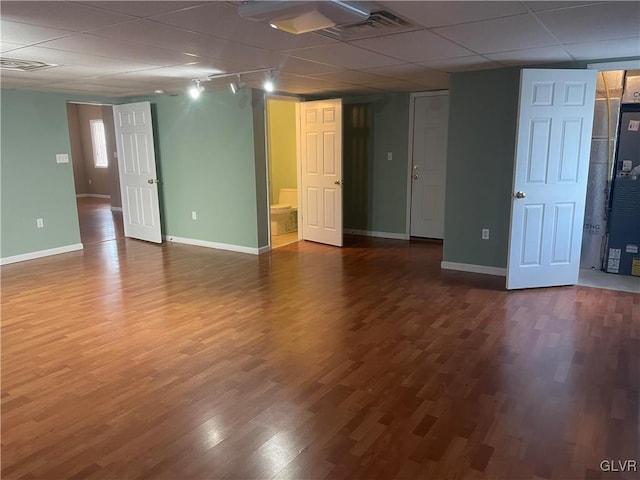 interior space with a paneled ceiling and wood-type flooring