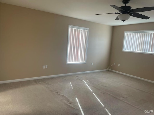 unfurnished room featuring ceiling fan and light colored carpet