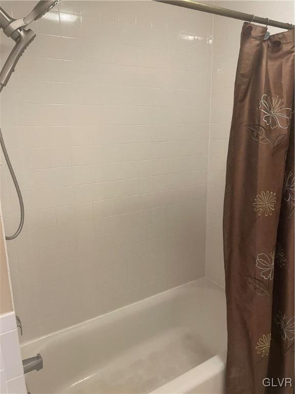 bathroom featuring shower / bathtub combination with curtain