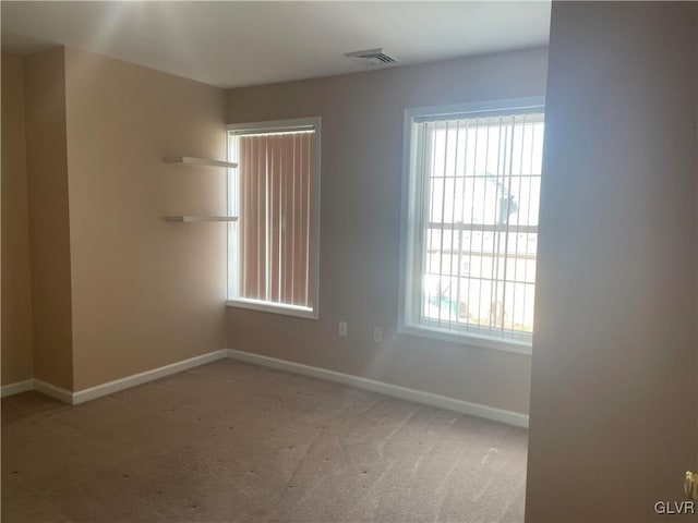 spare room with light carpet