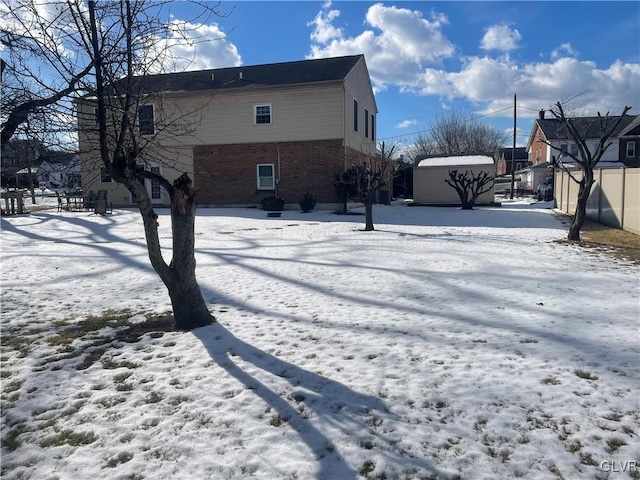 view of snow covered rear of property