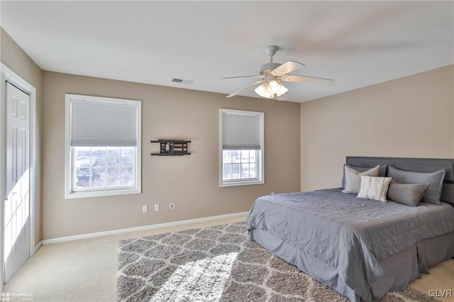 bedroom featuring light colored carpet and ceiling fan