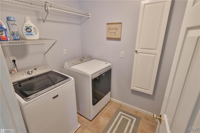 laundry area featuring light tile patterned flooring and separate washer and dryer