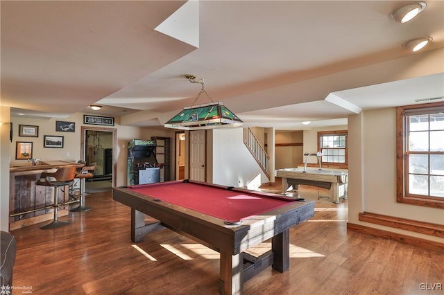 playroom with bar, wood-type flooring, and pool table