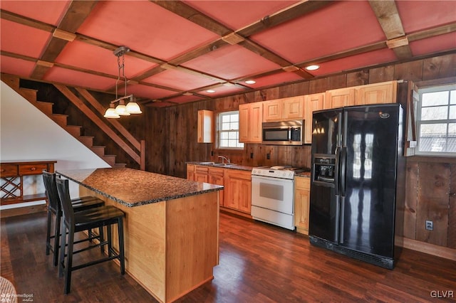 kitchen with wooden walls, decorative light fixtures, white gas range, coffered ceiling, and black refrigerator with ice dispenser