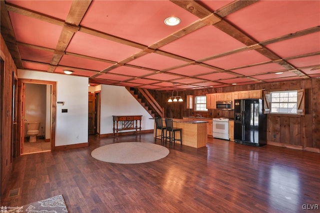 interior space featuring wooden walls, dark hardwood / wood-style floors, and sink