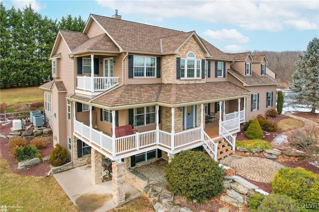 view of front of house featuring cooling unit, a porch, and a patio