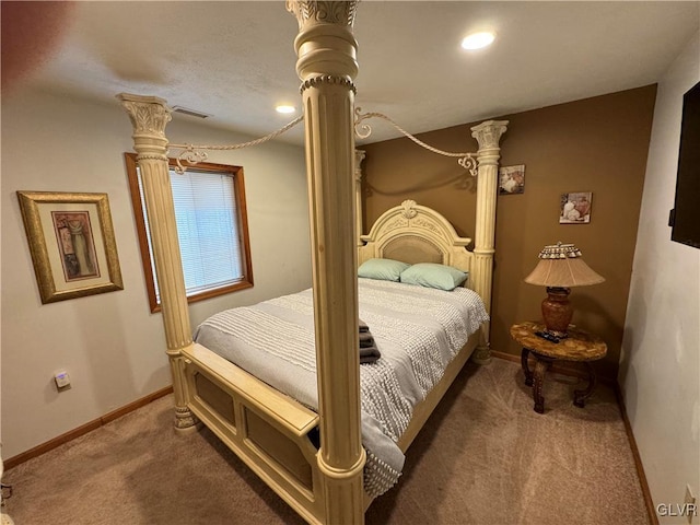 bedroom featuring carpet flooring and decorative columns