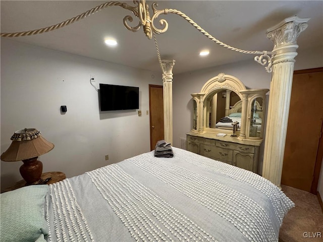 bedroom featuring decorative columns and carpet flooring