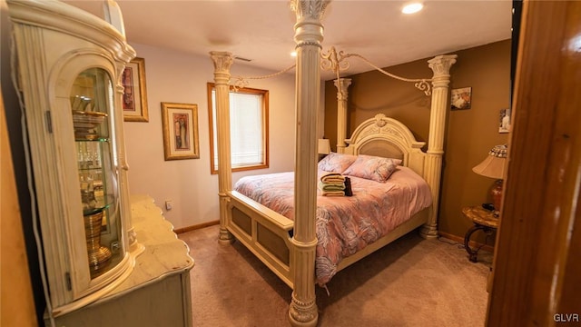 bedroom featuring decorative columns and dark carpet