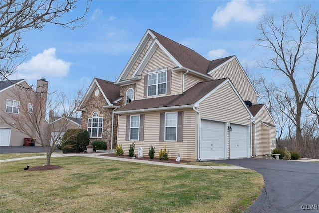 front of property featuring a garage and a front lawn