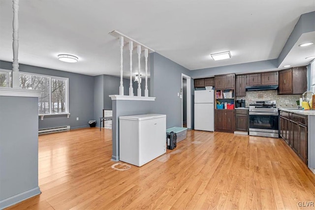 kitchen featuring dark brown cabinetry, white refrigerator, fridge, baseboard heating, and stainless steel stove