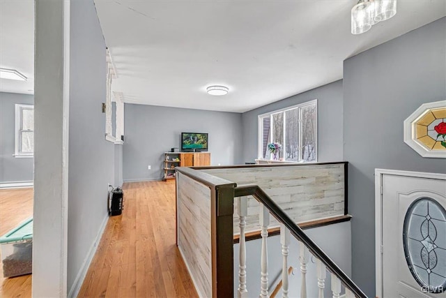 hall featuring a baseboard radiator and light wood-type flooring