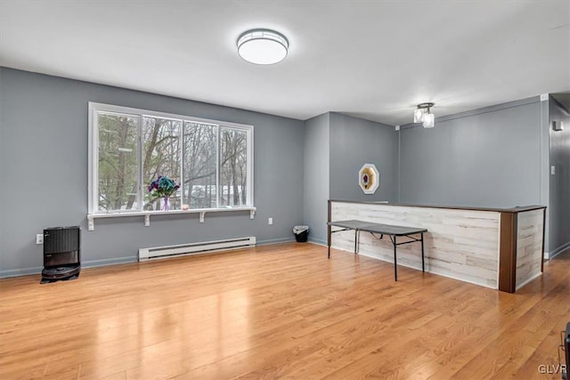 interior space featuring light hardwood / wood-style floors and a baseboard heating unit