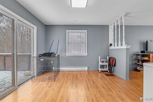 miscellaneous room with light hardwood / wood-style flooring and a baseboard radiator