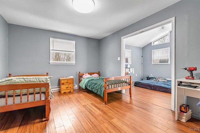 bedroom featuring vaulted ceiling and light hardwood / wood-style floors