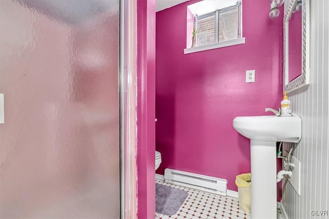 bathroom with a baseboard radiator, toilet, and walk in shower