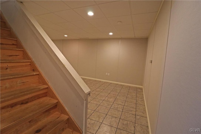 staircase featuring a drop ceiling