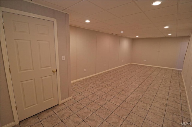 basement with a paneled ceiling