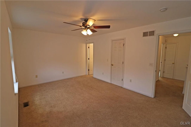 unfurnished bedroom featuring light carpet and ceiling fan