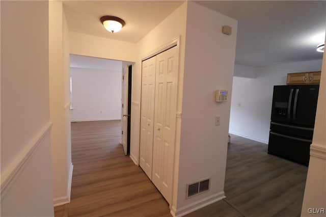 corridor with dark hardwood / wood-style flooring