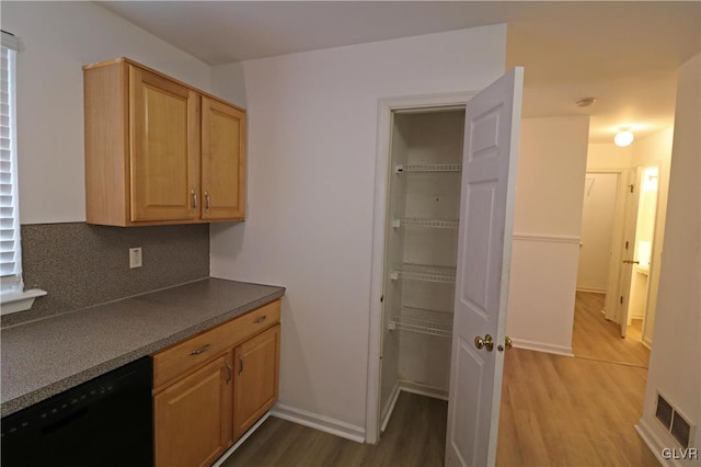 kitchen with backsplash, hardwood / wood-style flooring, and dishwasher