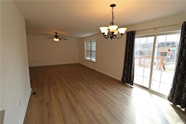 unfurnished room featuring ceiling fan with notable chandelier and wood-type flooring