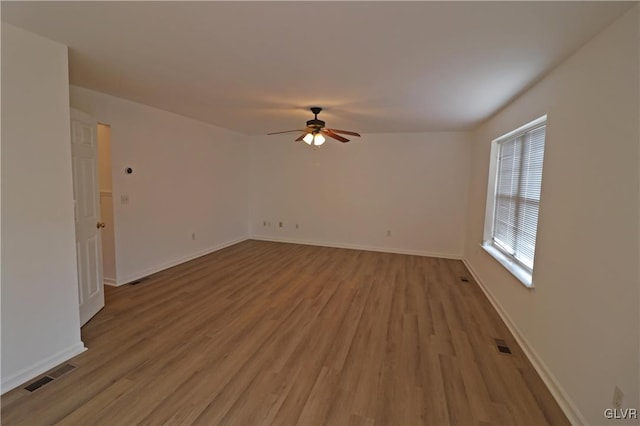 spare room featuring light hardwood / wood-style floors and ceiling fan