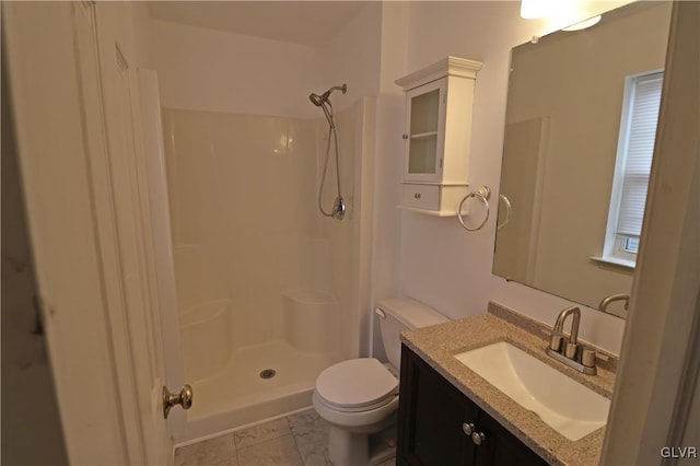 bathroom with walk in shower, vanity, and toilet