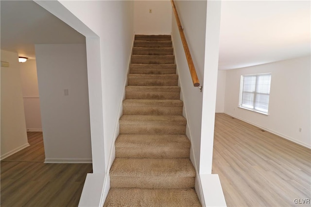 stairway with hardwood / wood-style floors