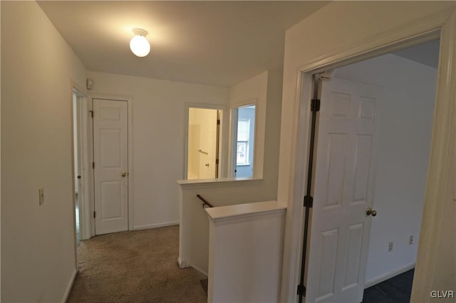 hall featuring dark colored carpet