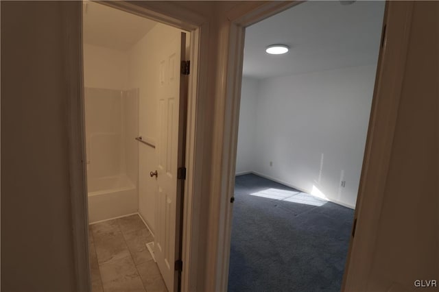 hallway featuring light colored carpet