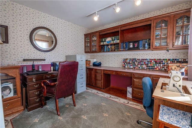 office featuring dark tile patterned floors and built in desk